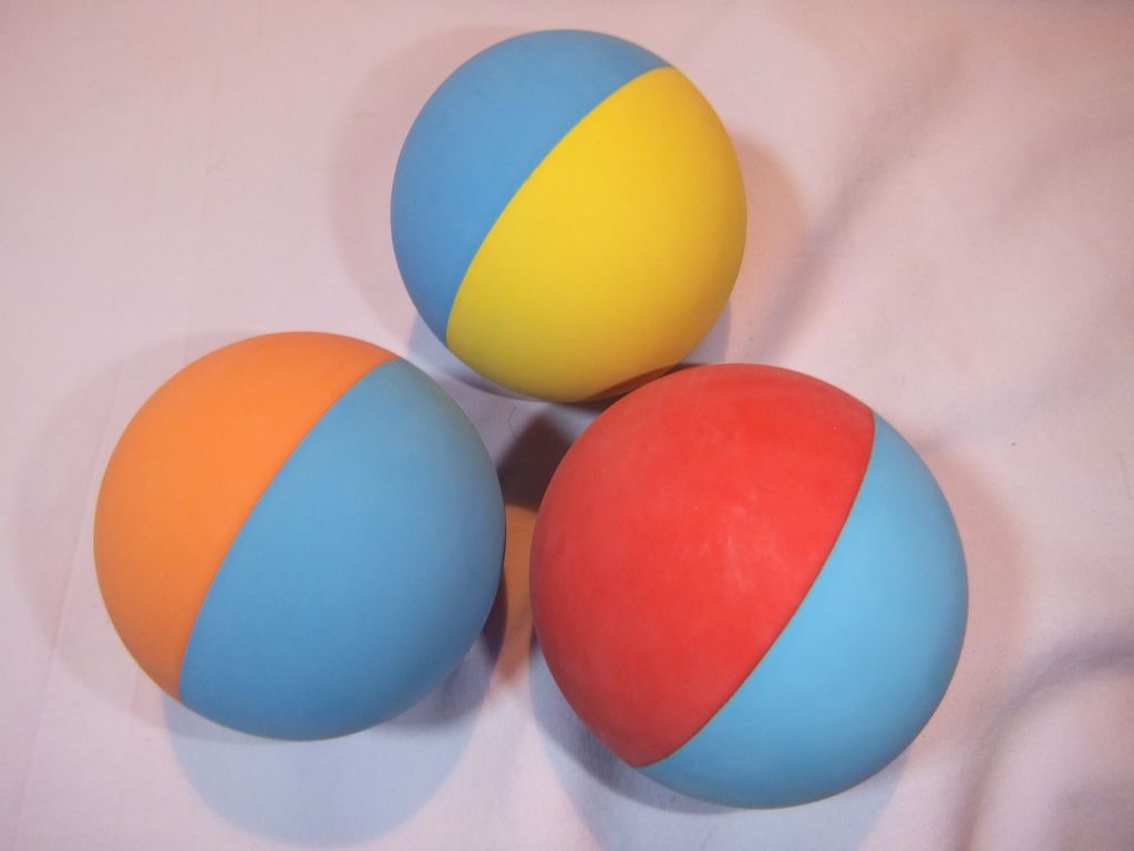orange and blue rubber dog balls